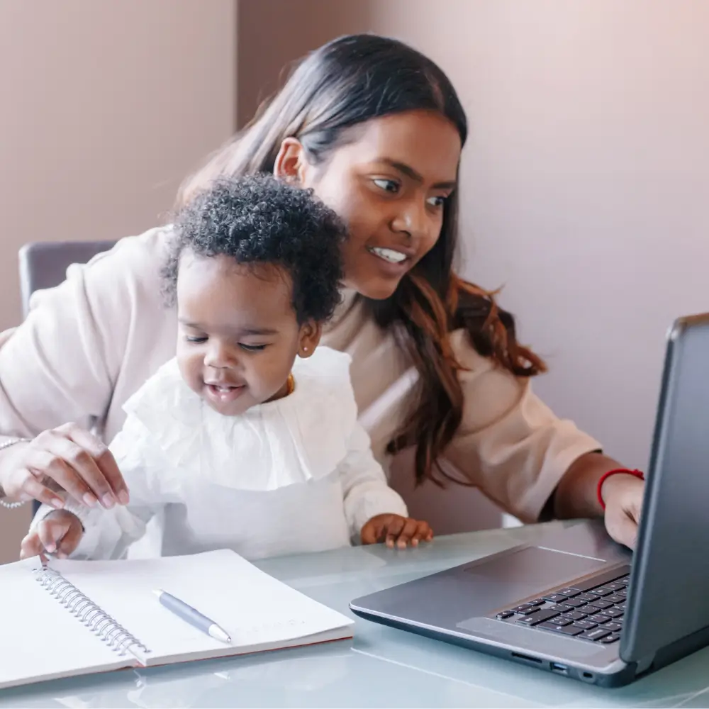 BIPOC woman meets with financial planner virtually with young child on her lap
